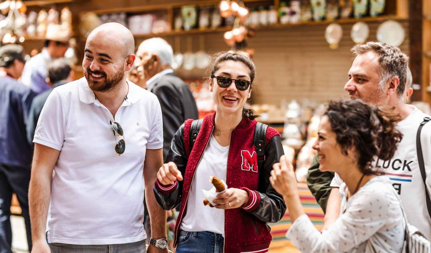 Two men and two women are conversing in a public space in Istanbul