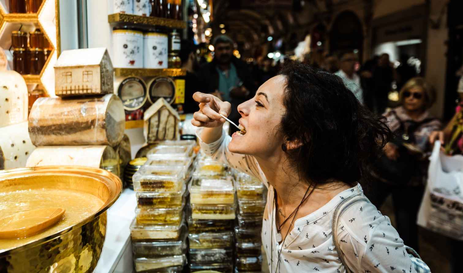 Shoppers browsing in a market with honey products in Istanbul