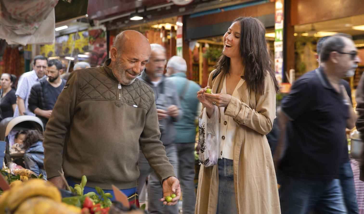 Busy market with people browsing fruits and vegetables in Istanbul
