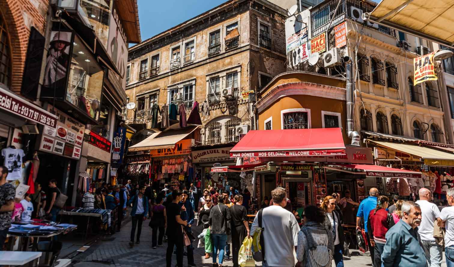 Street scene in Istanbul with people walking and shopping.