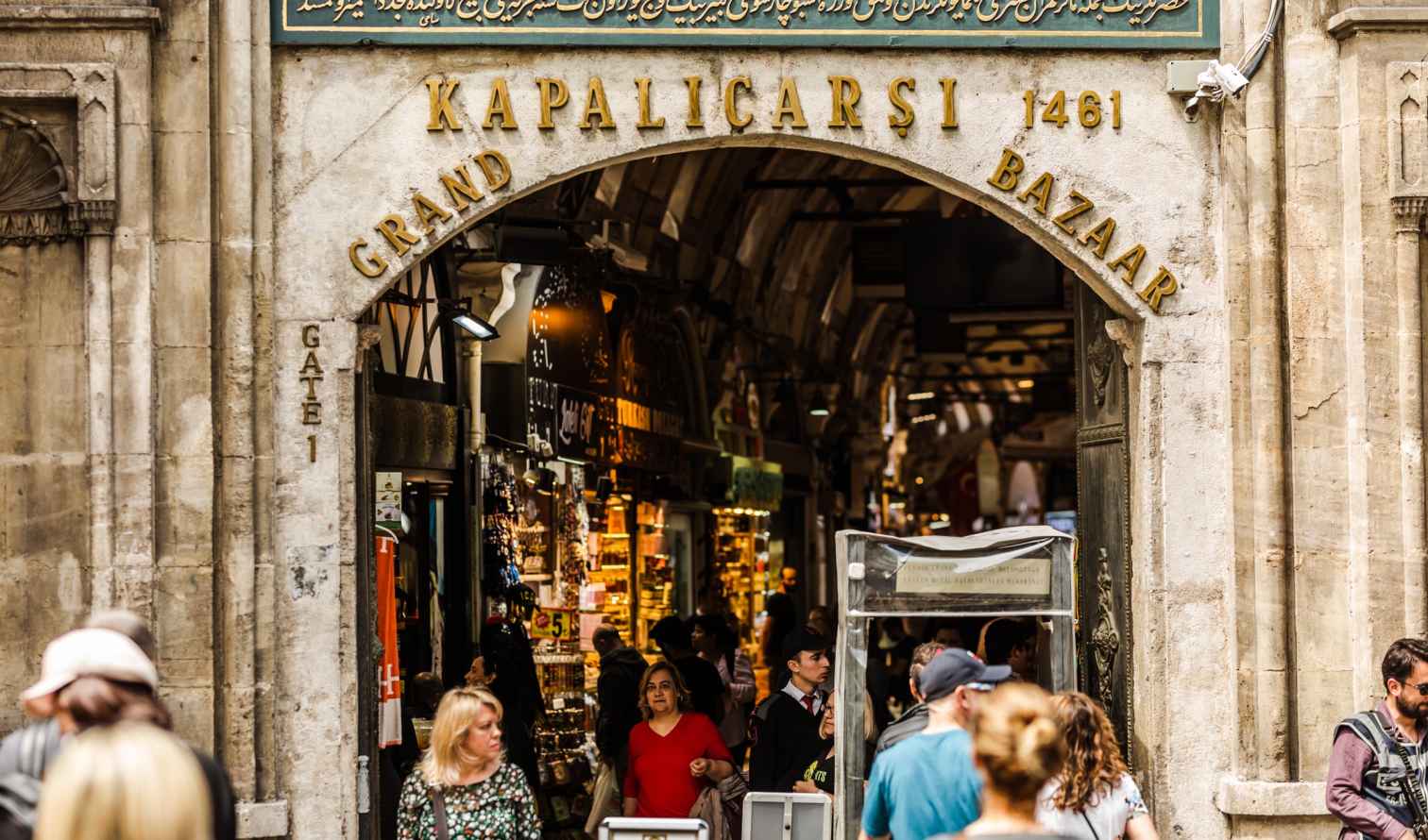 Crowd of people walking through the Grand Bazaar gate in Istanbul.