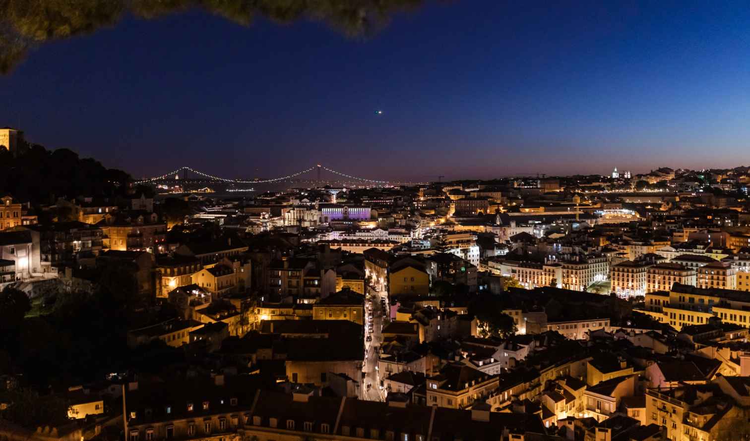 Night view of Lisbon with the 25 de Abril Bridge in the background in Lisbon