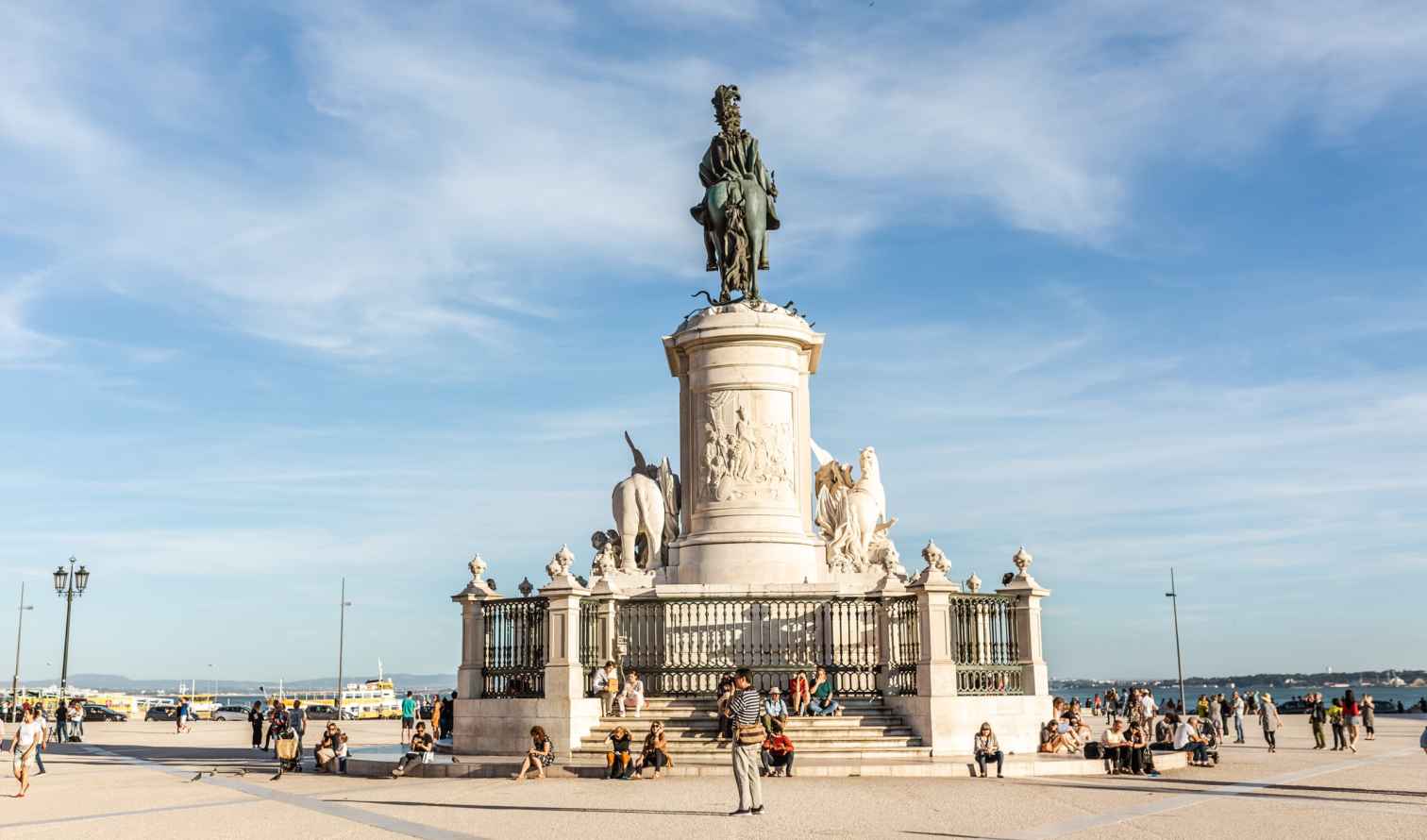 Statue of King José I at Praça do Comércio, Lisbon, with people around.