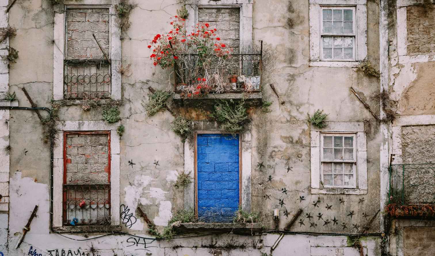 Old building facade with blue door in Lisbon, Portugal.