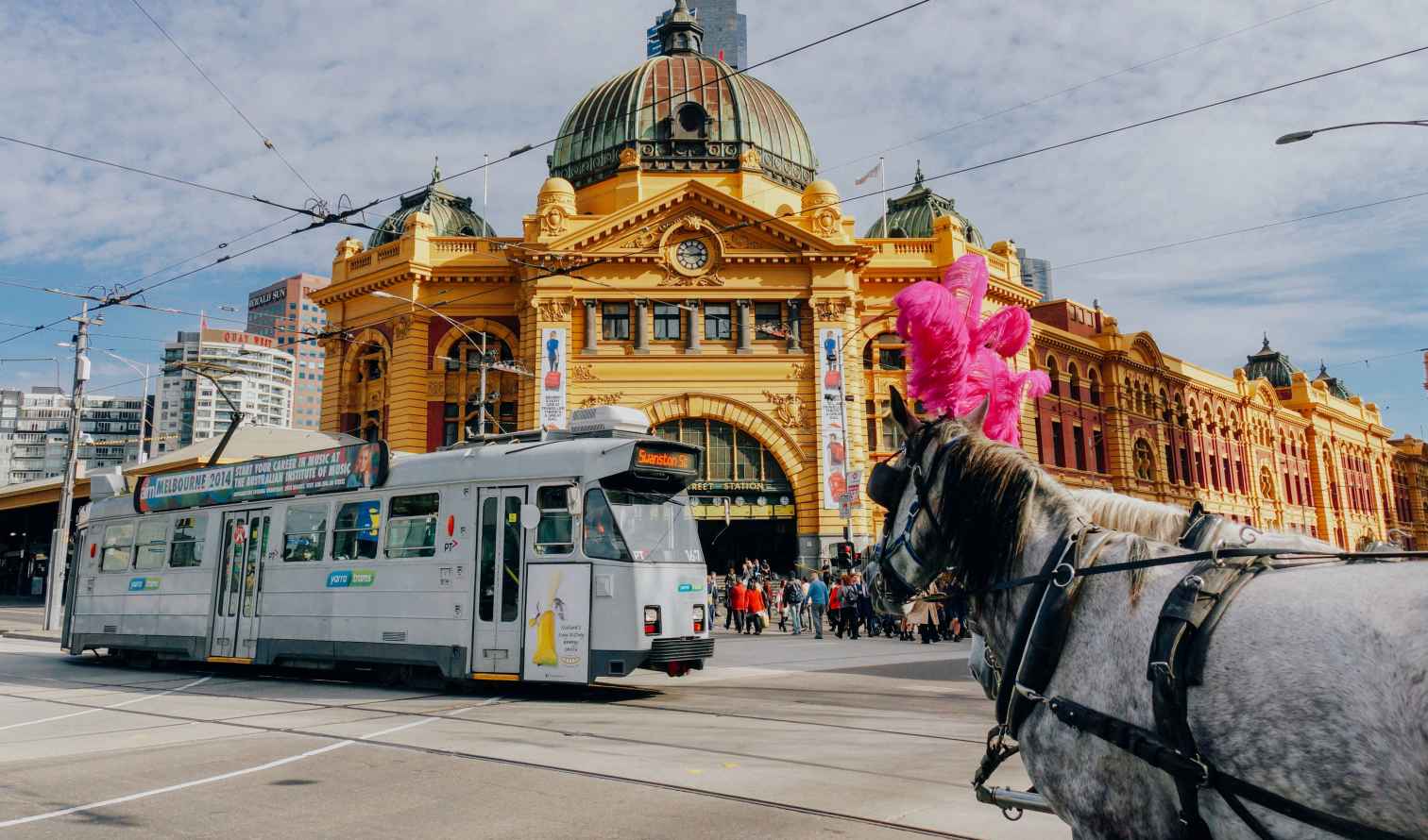 Flinders Street Station with a tram passing in front in Melbourne, Australia.