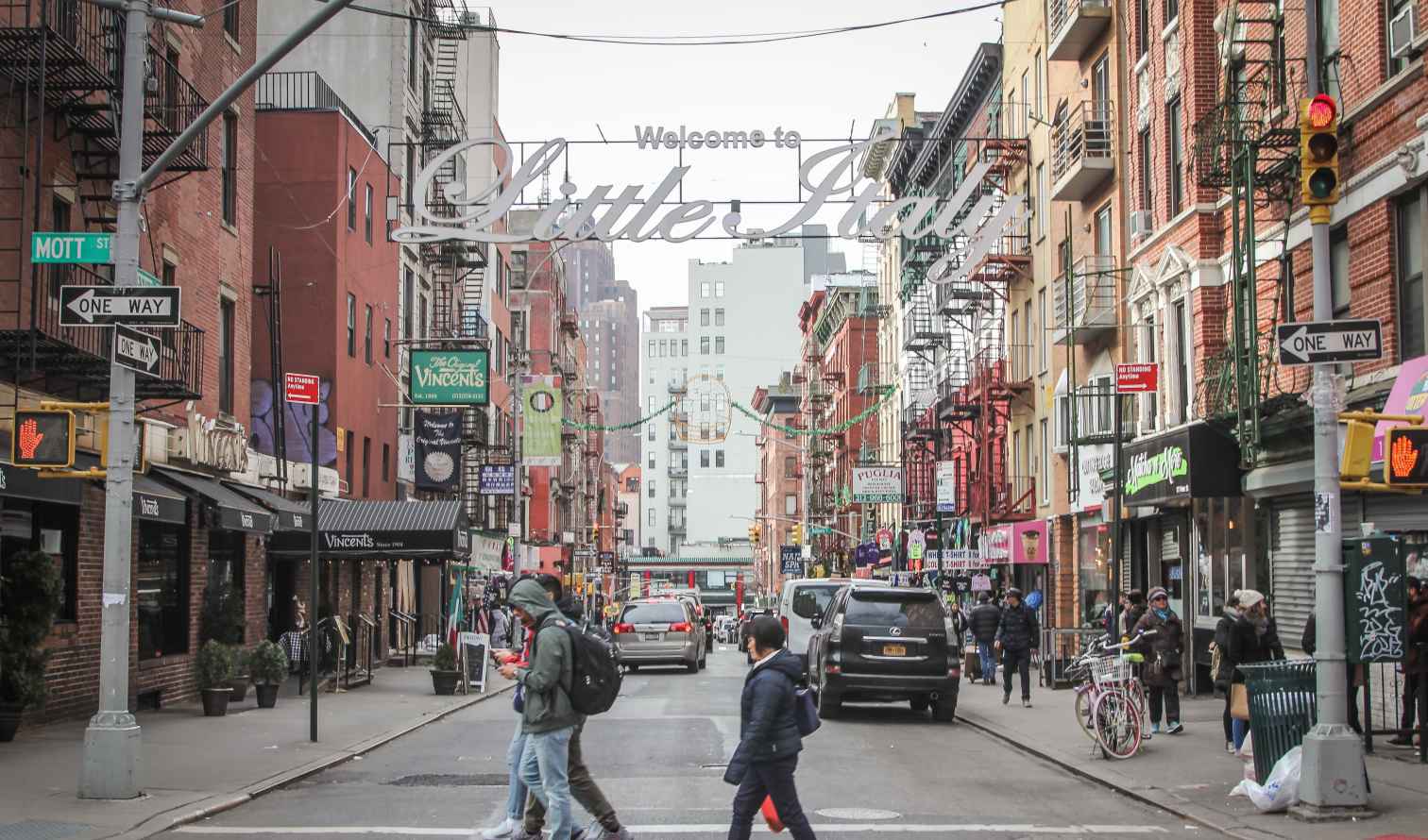 People crossing a street in Little Italy, New York City.
