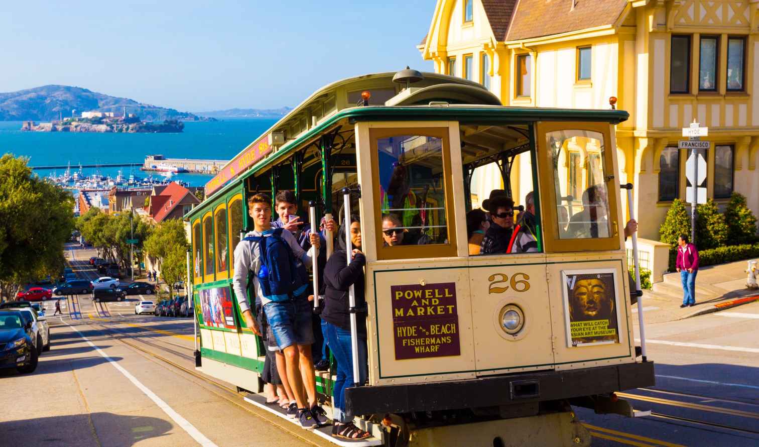 San Francisco cable car on Hyde Street with Alcatraz in background.