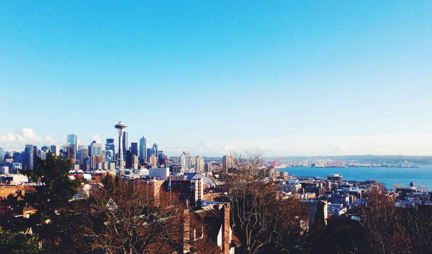 Seattle skyline including the Space Needle under a clear blue sky.