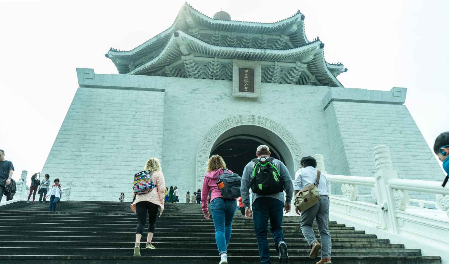 People walking up steps to Chiang Kai-shek Memorial Hall in Taipei.