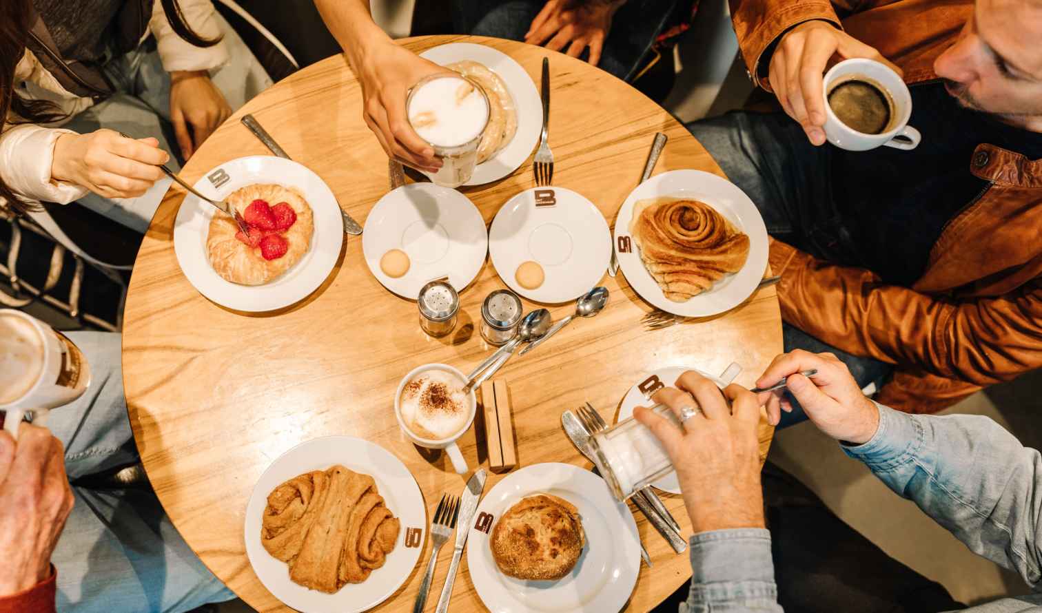Top-down view of a cafe table with pastries and coffee in Hamburg