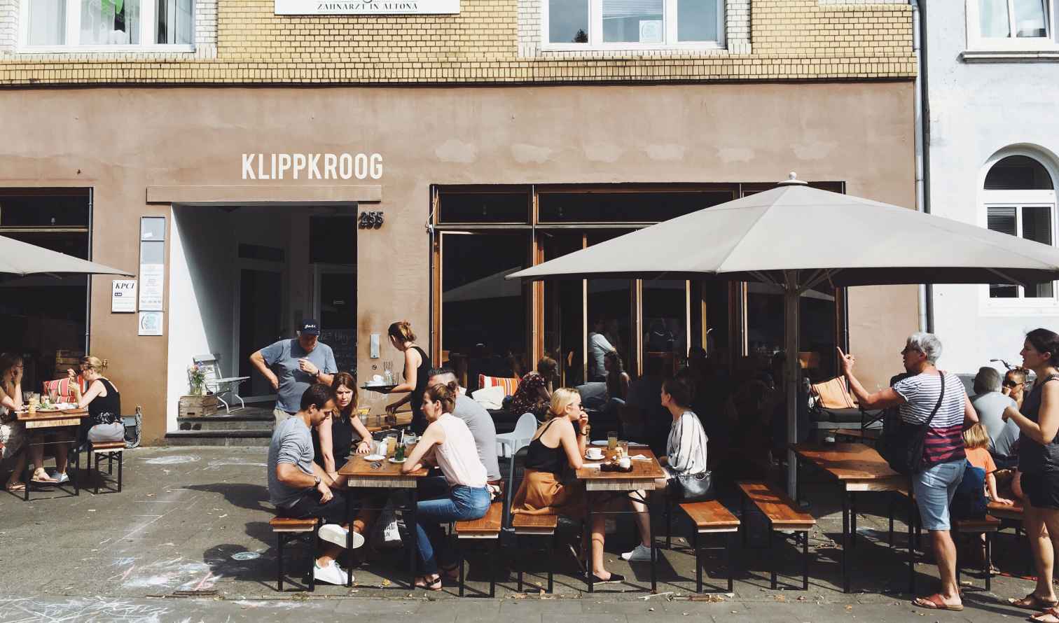 People dining outside Klippkroog, a cafe in Altona, Hamburg.
