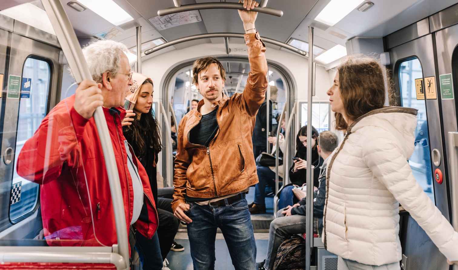 Passengers standing and sitting inside a subway train in Hamburg