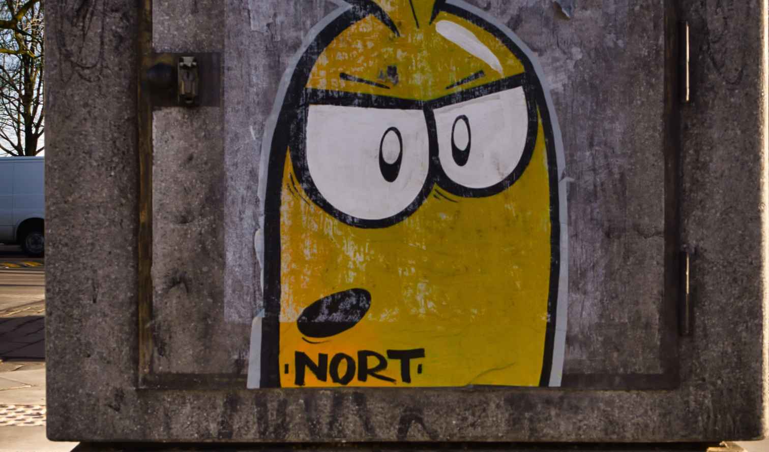 Street art featuring a yellow cartoon character on a concrete wall.Hamburg