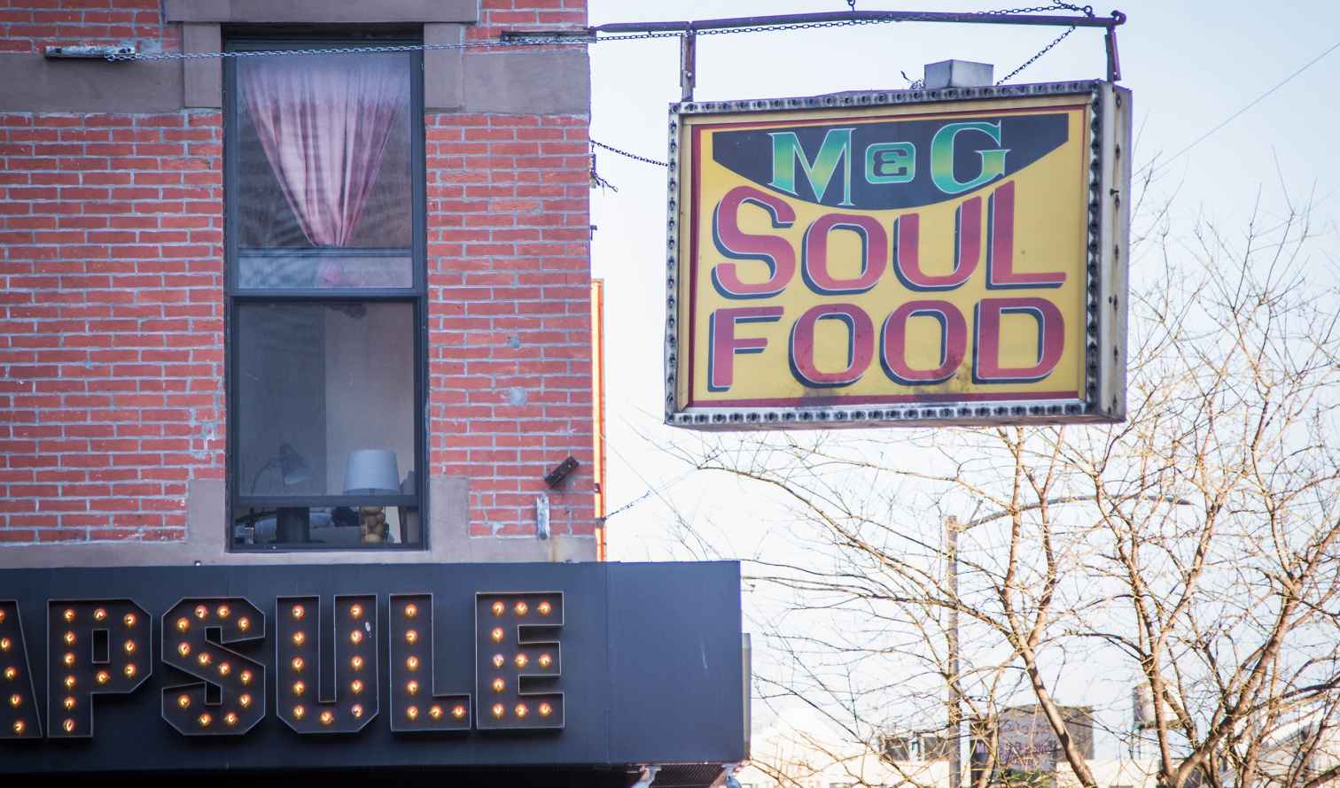 M&amp;G Soul Food sign hangs on a brick building in New York