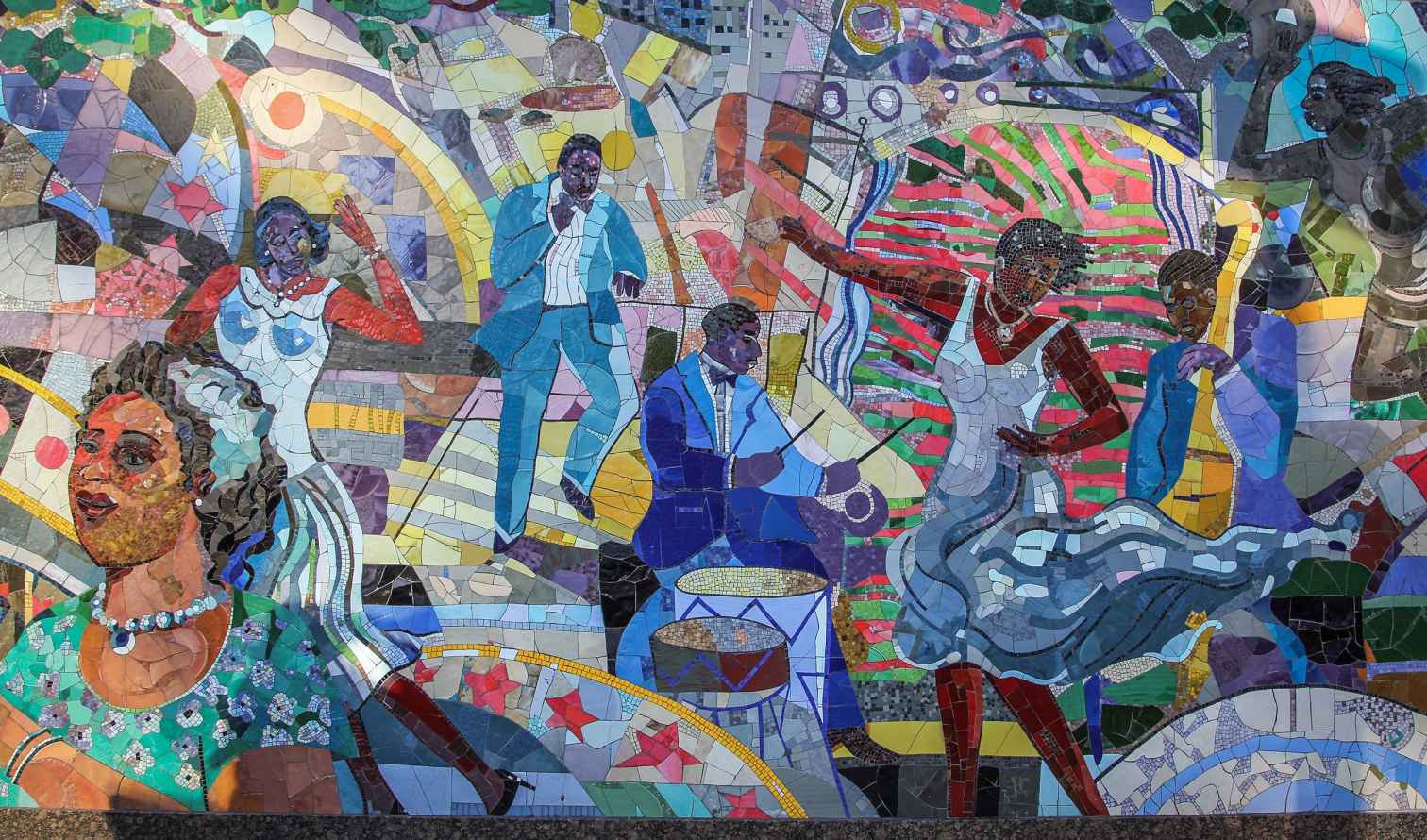 Colorful mosaic with people playing instruments and dancing in New York