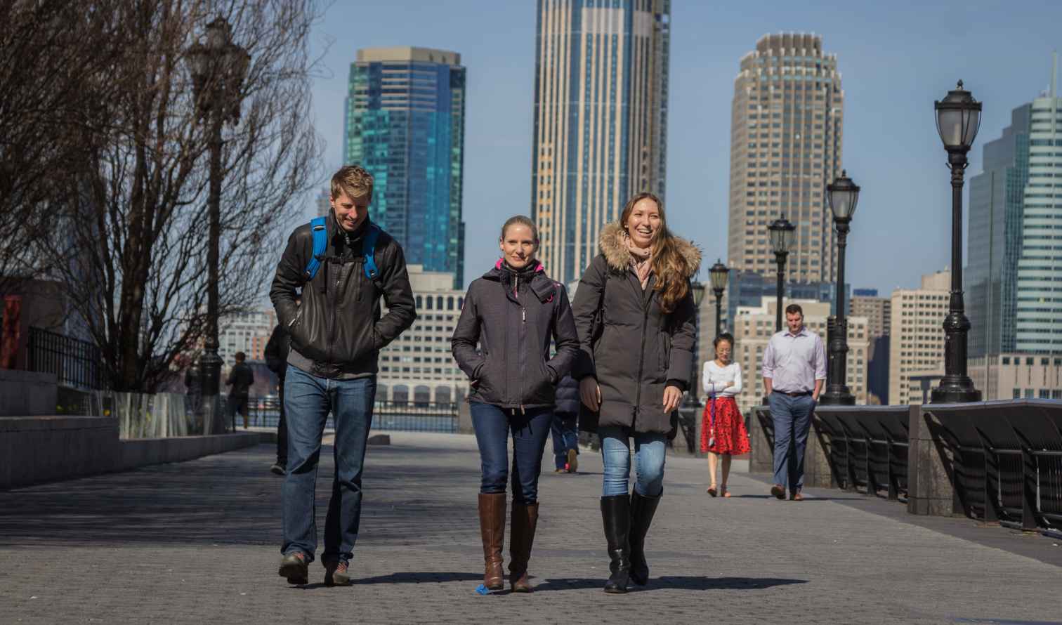 People walking along a pathway in New York City.
