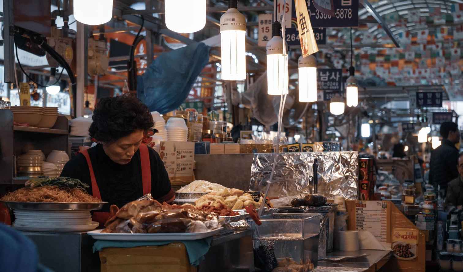 Vendor preparing food in Gwangjang Market, Seoul, South Korea.