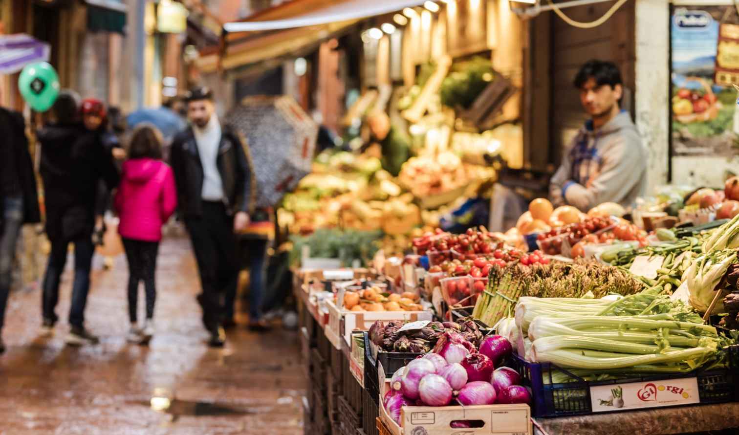 Outdoor market with fresh produce in Bologna, Italy.