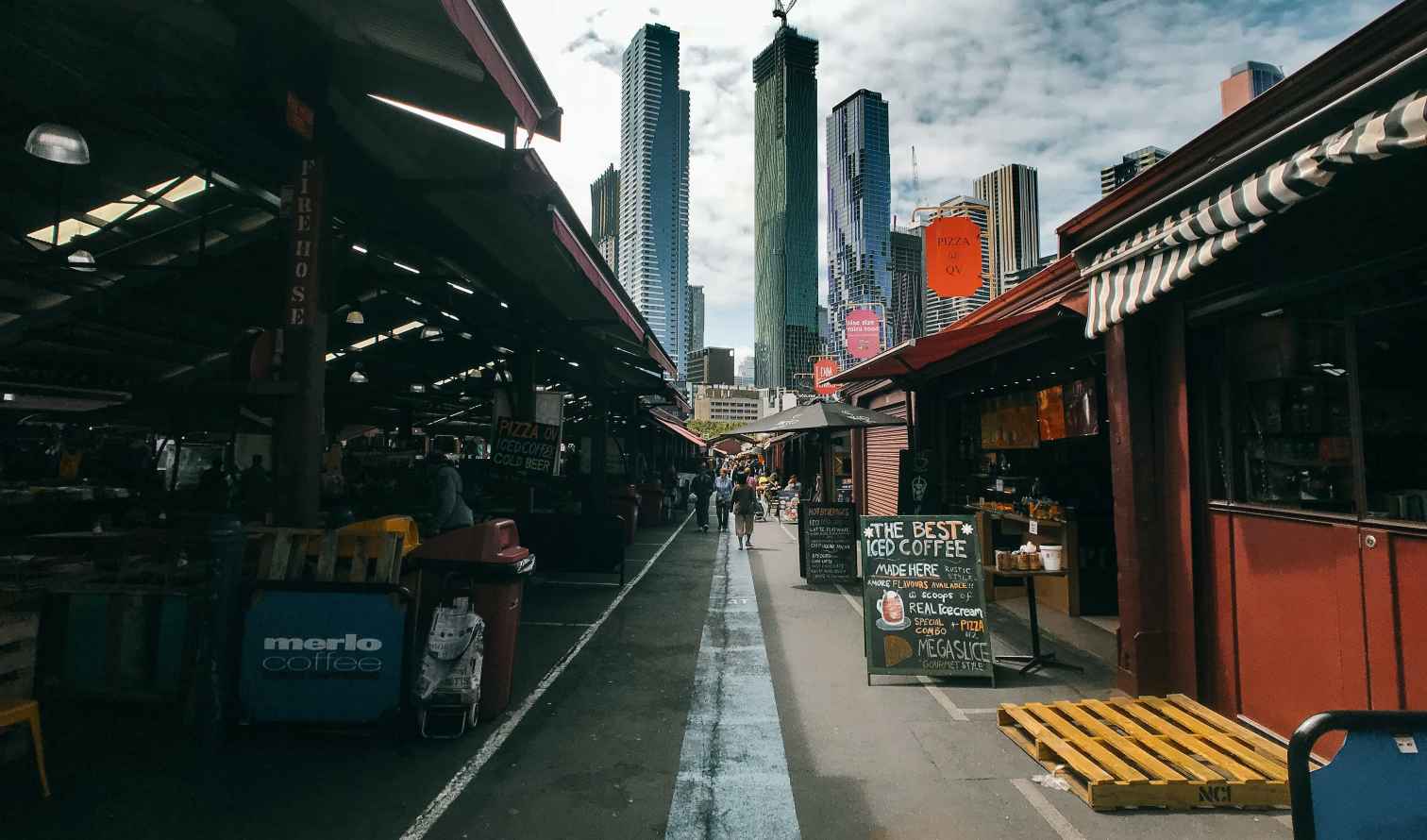 Street view of Queen Victoria Market with skyscrapers in the background in Melbourne