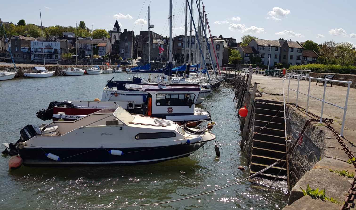 Docked and moored vessels at North Berwick harbor on a sunny day in Edinburgh