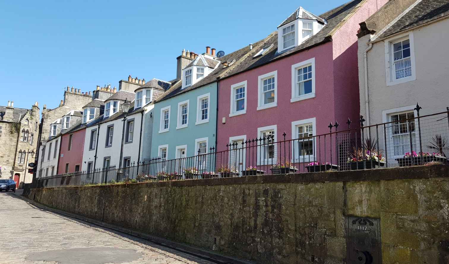 Colorful houses along a cobblestone street in Culross, Edinburgh, Scotland
