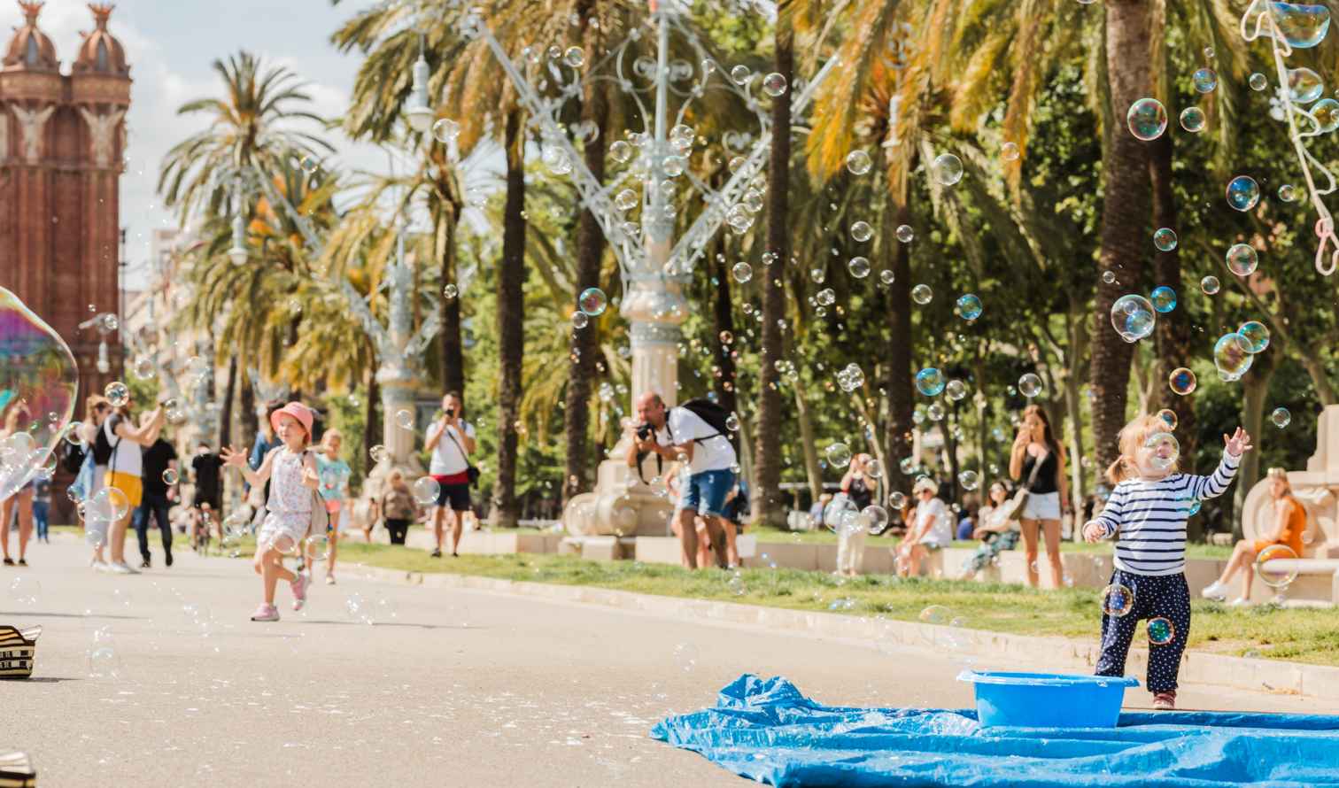 Children playing with bubbles near Arc de Triomf, Barcelona.