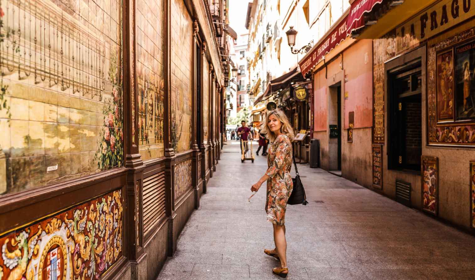 Calle de Cuchilleros in Madrid with decorative tiles on restaurant walls.