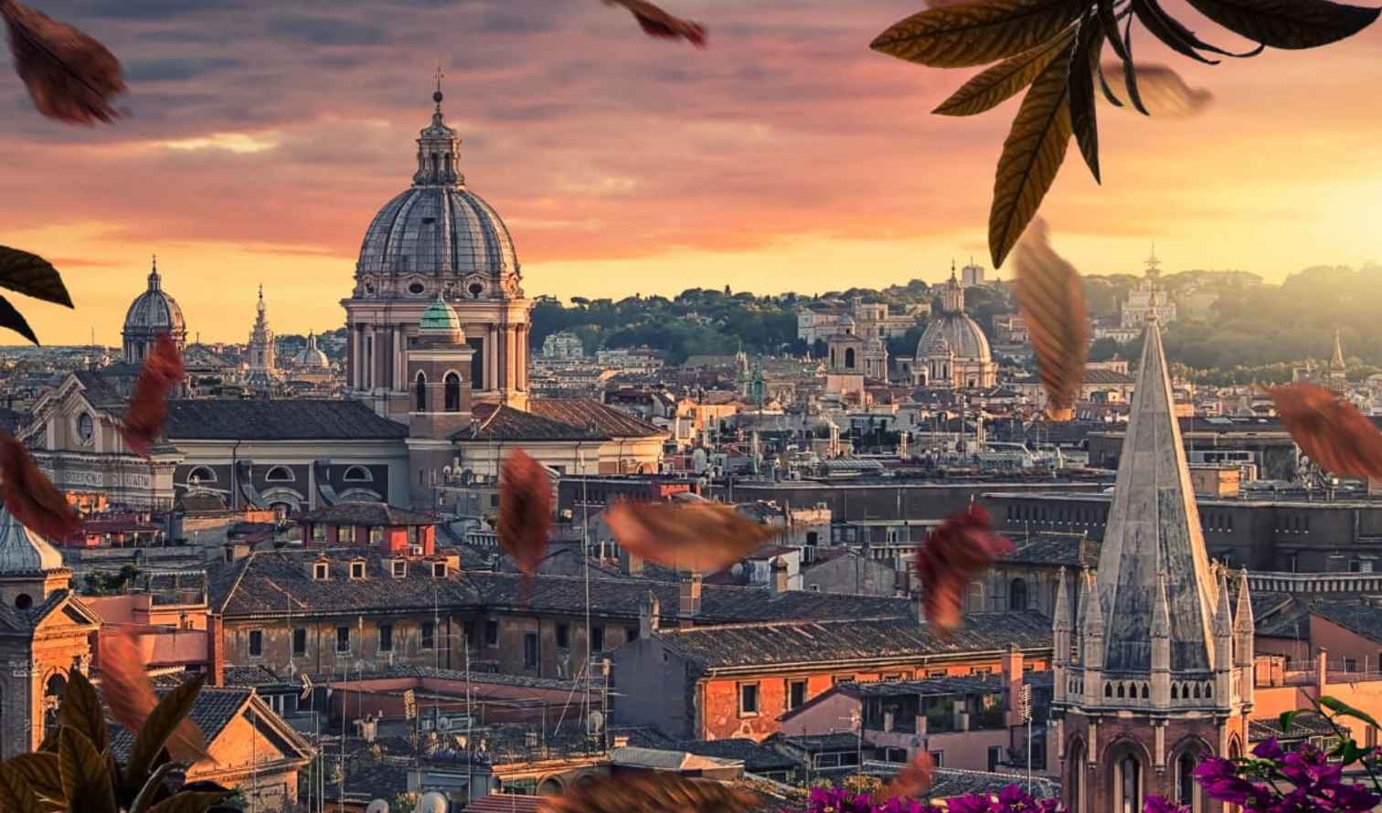 Skyline of Rome with St. Peter's Basilica dome at sunset.