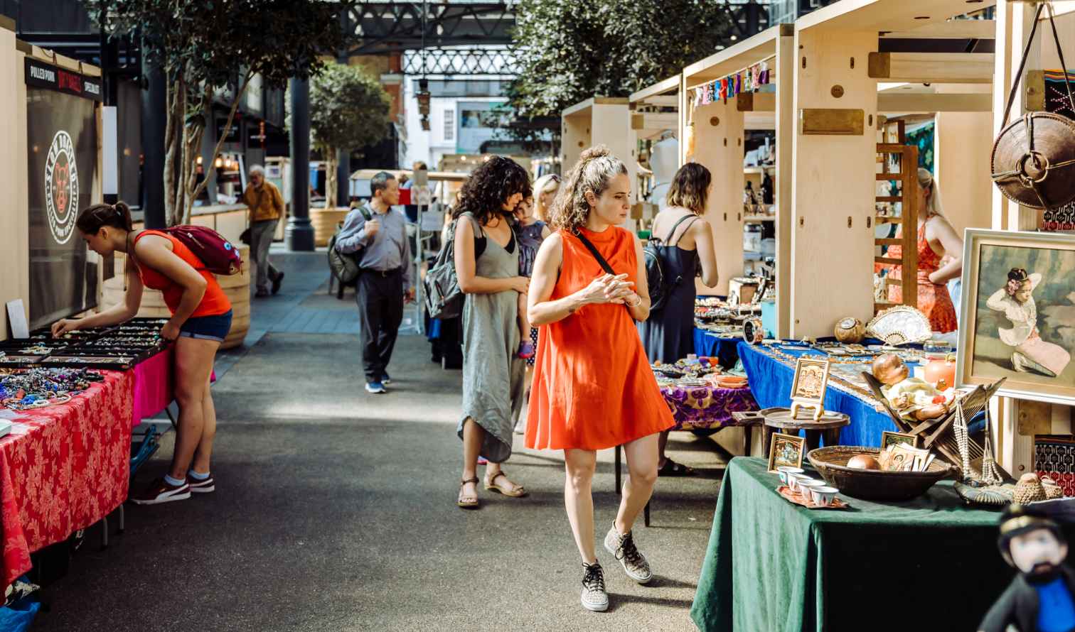 People browsing stalls at Old Spitalfields Market in London.