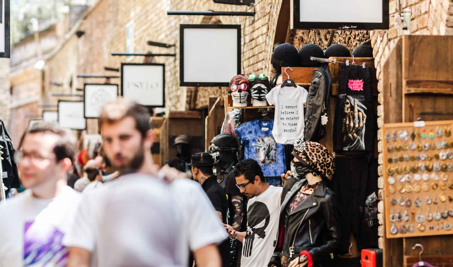 People walking past market stalls on Brick Lane, London.