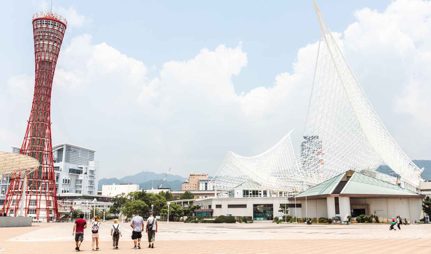 Kobe Port Tower and Maritime Museum in Kobe, Japan under a blue sky.