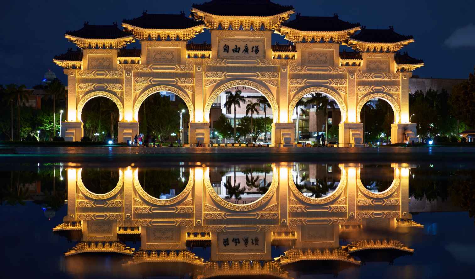 Liberty Square entrance gate with night lighting and reflection, Taipei, Taiwan.