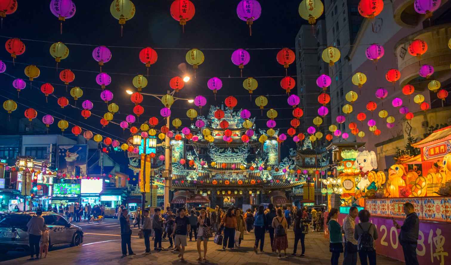 Colorful lanterns hang above the crowd at a night market in Taipei, Taiwan.
