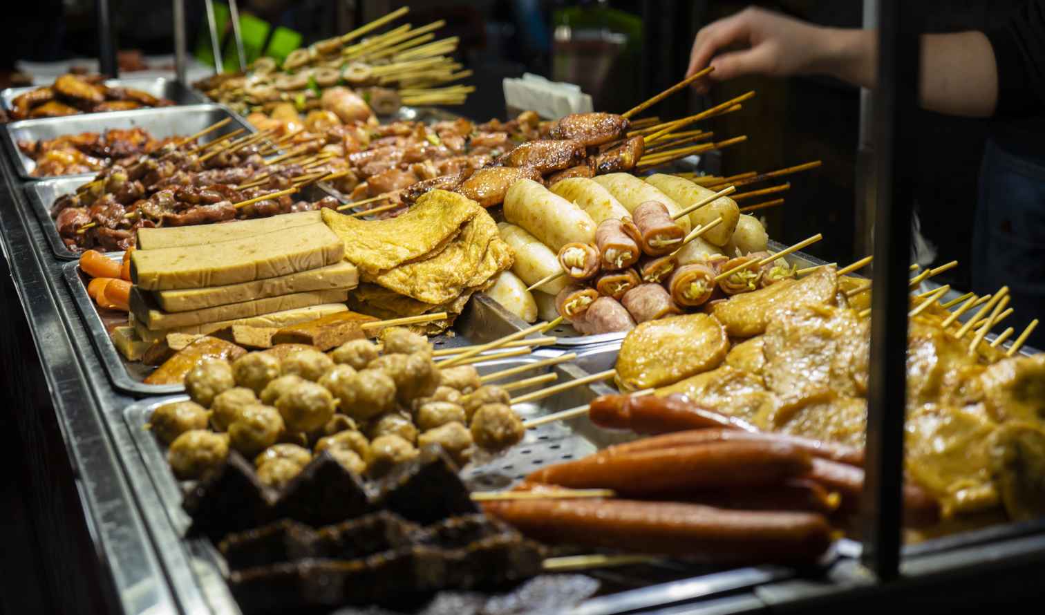 Street food skewers displayed at a night market stall in Taipei