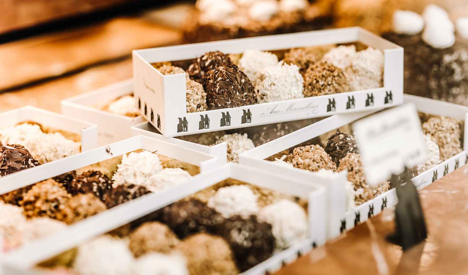 Close-up of chocolate and cream pastries in decorative boxes in Brussels