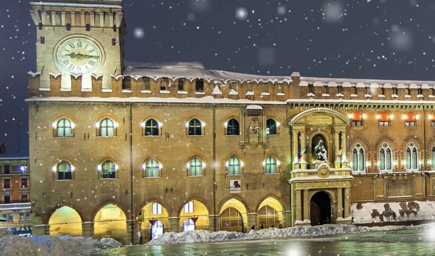 Palazzo d'Accursio in Piazza Maggiore, Barcelona, illuminated at night in snowfall.