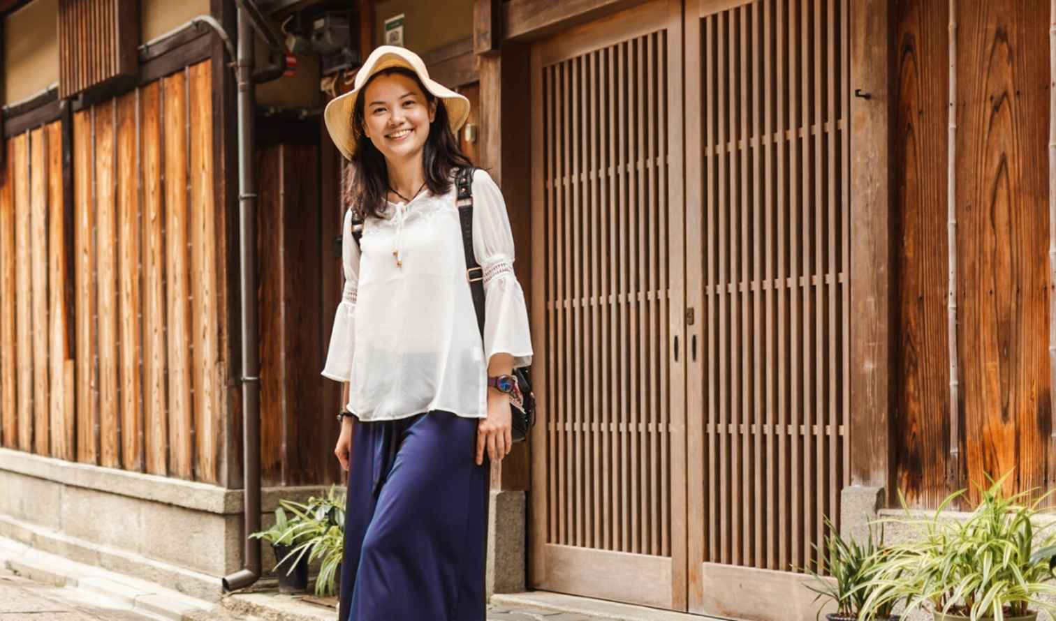 Woman standing on a traditional street in Osaka, Japan.