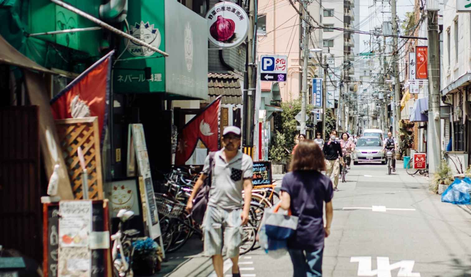 A street in Osaka lined with small shops and bicycles.