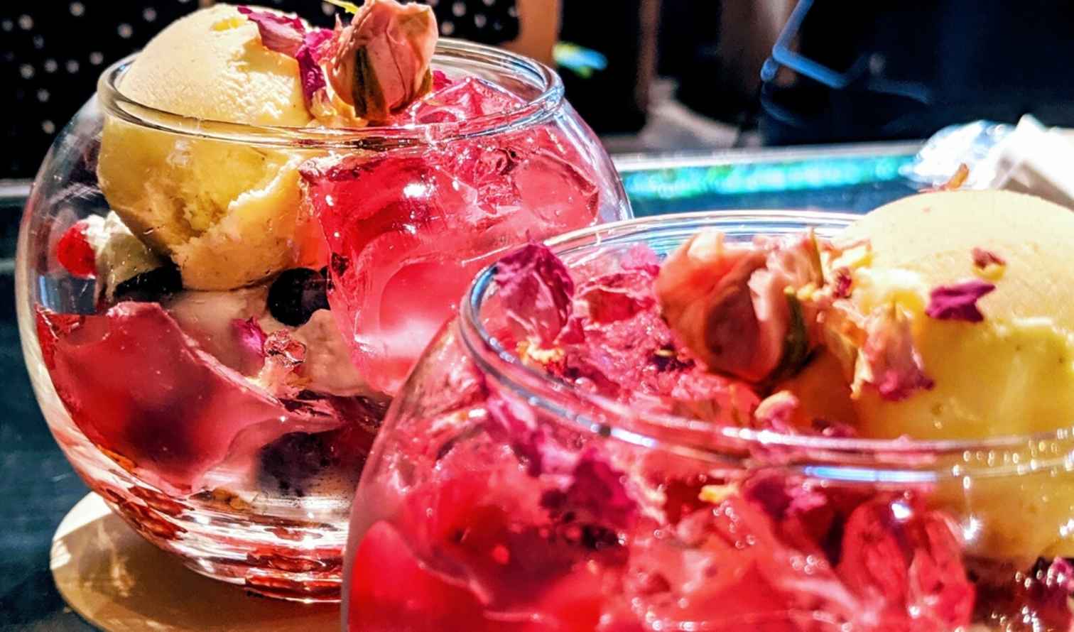 Two glass bowls of rose petal ice cream and jelly on a table Osaka