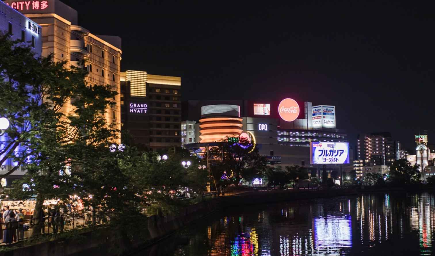 People gathering at yatai street stalls near Naka River in Fukuoka, Japan.