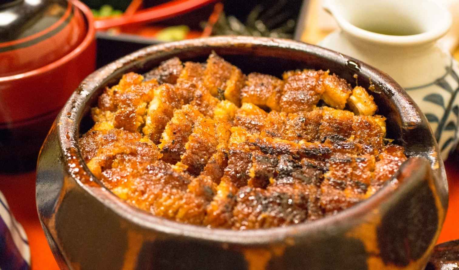 Traditional unagi don with ceramic bowls and tea kettle in Nagoya