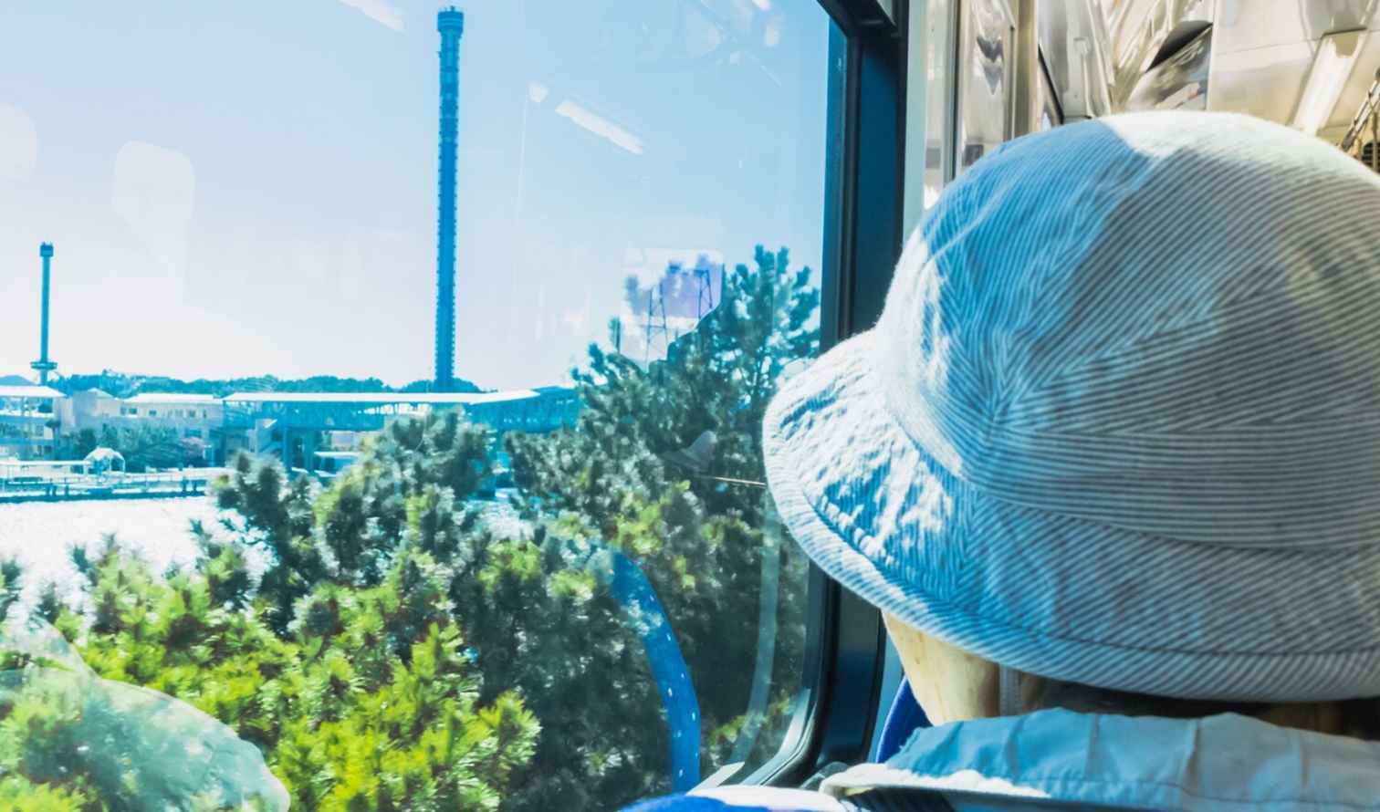 Moody Gardens pyramid and tower visible across the water from a train in Yokohama