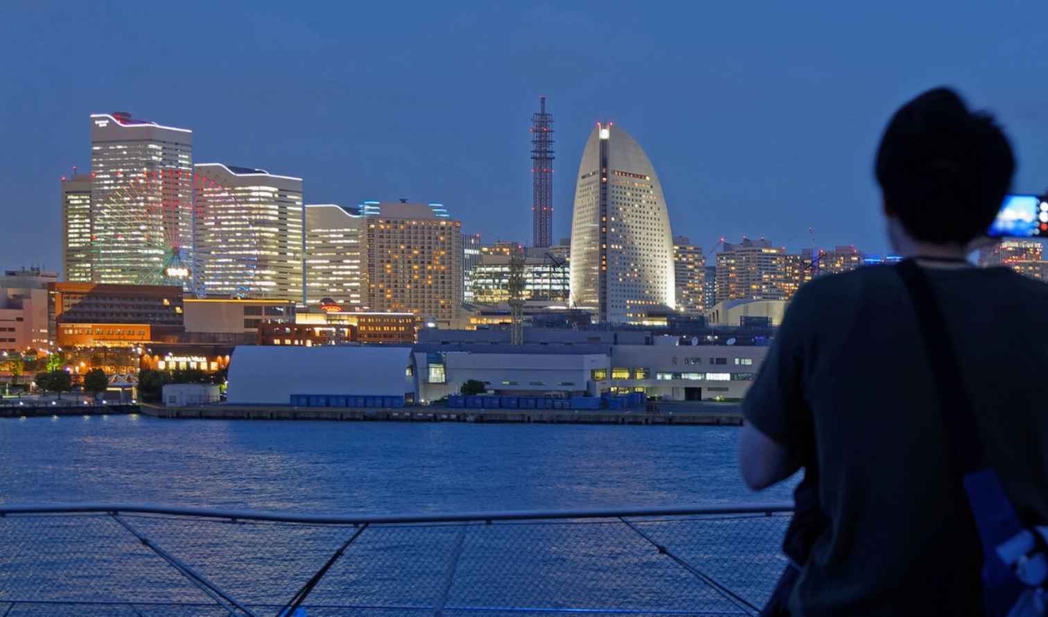 People taking photos of Yokohama skyline from Osanbashi Pier.