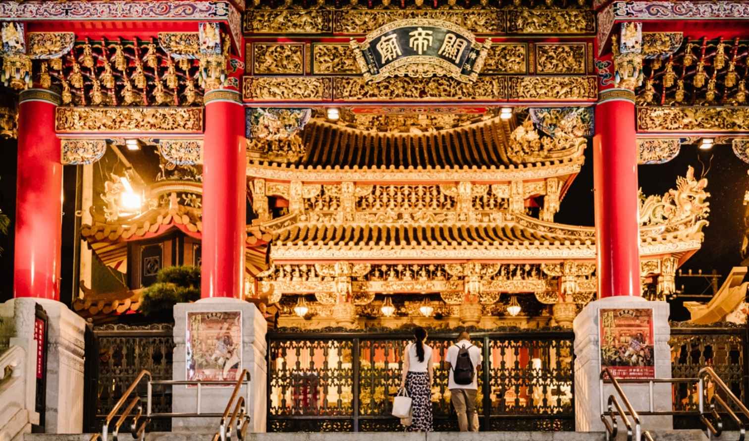 Two people standing in front of Ma Zhu Miao Temple in Yokohama.