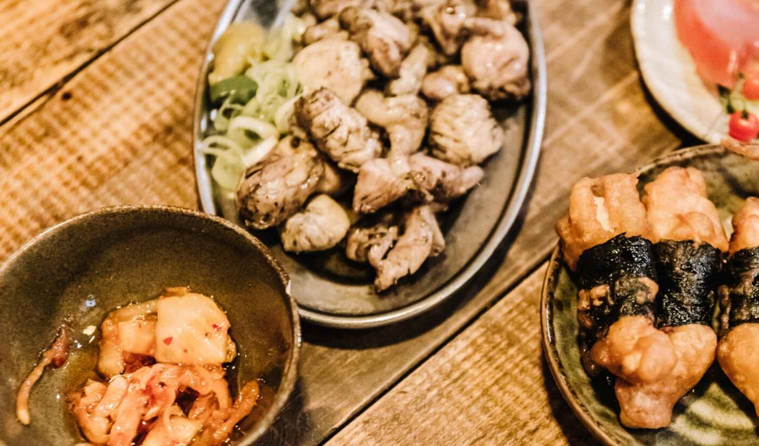 Assorted Korean dishes served on a wooden table in Nagoya