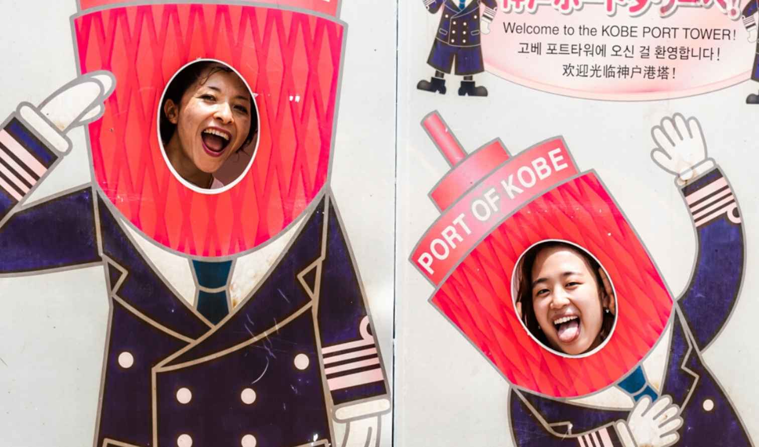 Visitors using photo board at Kobe Port Tower location.