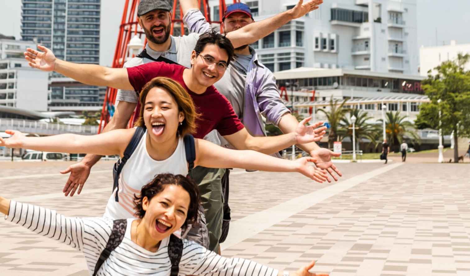 Group of people lining up along a promenade in Kobe Harborland.
