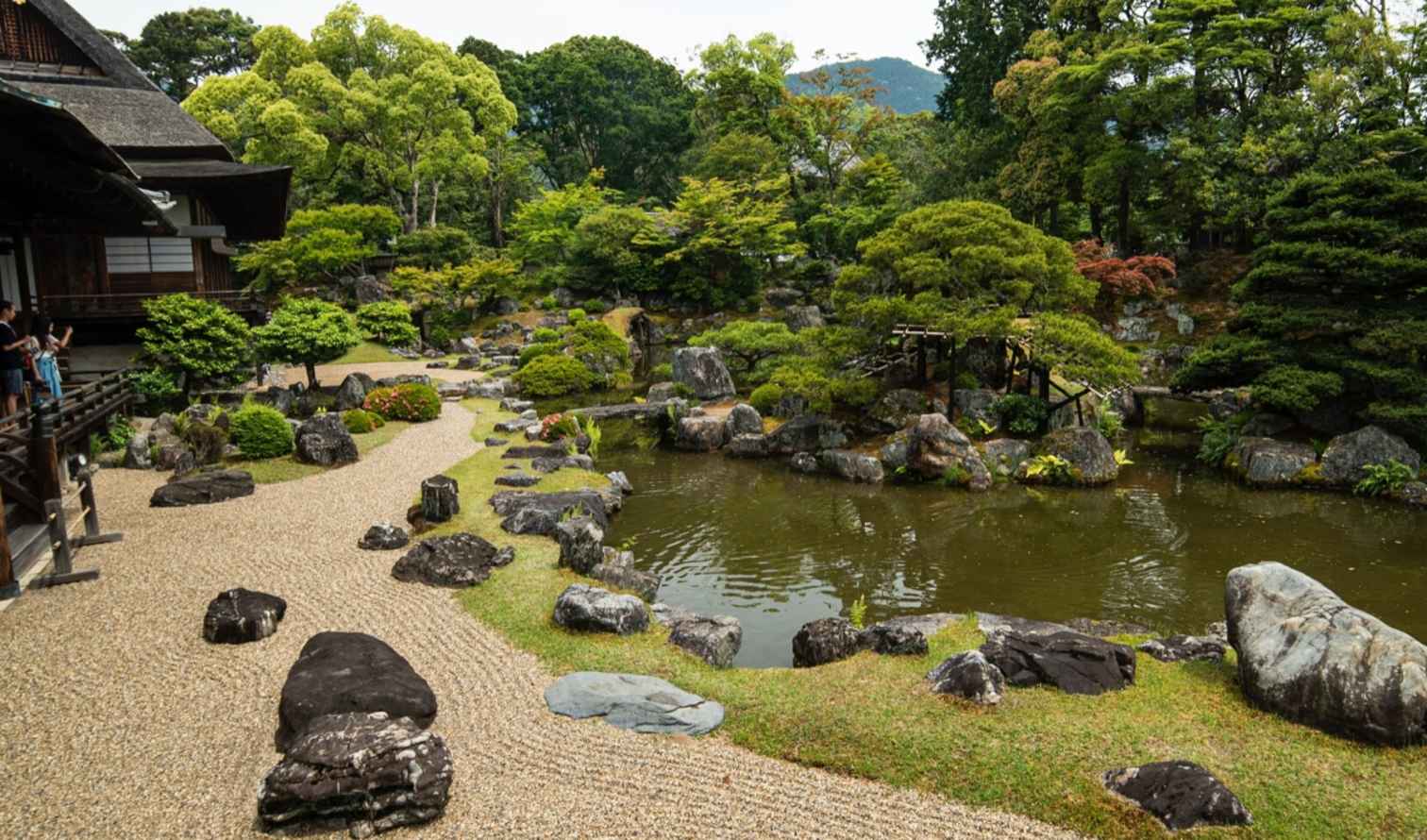 People standing on the porch of a Japanese wooden building in Osaka