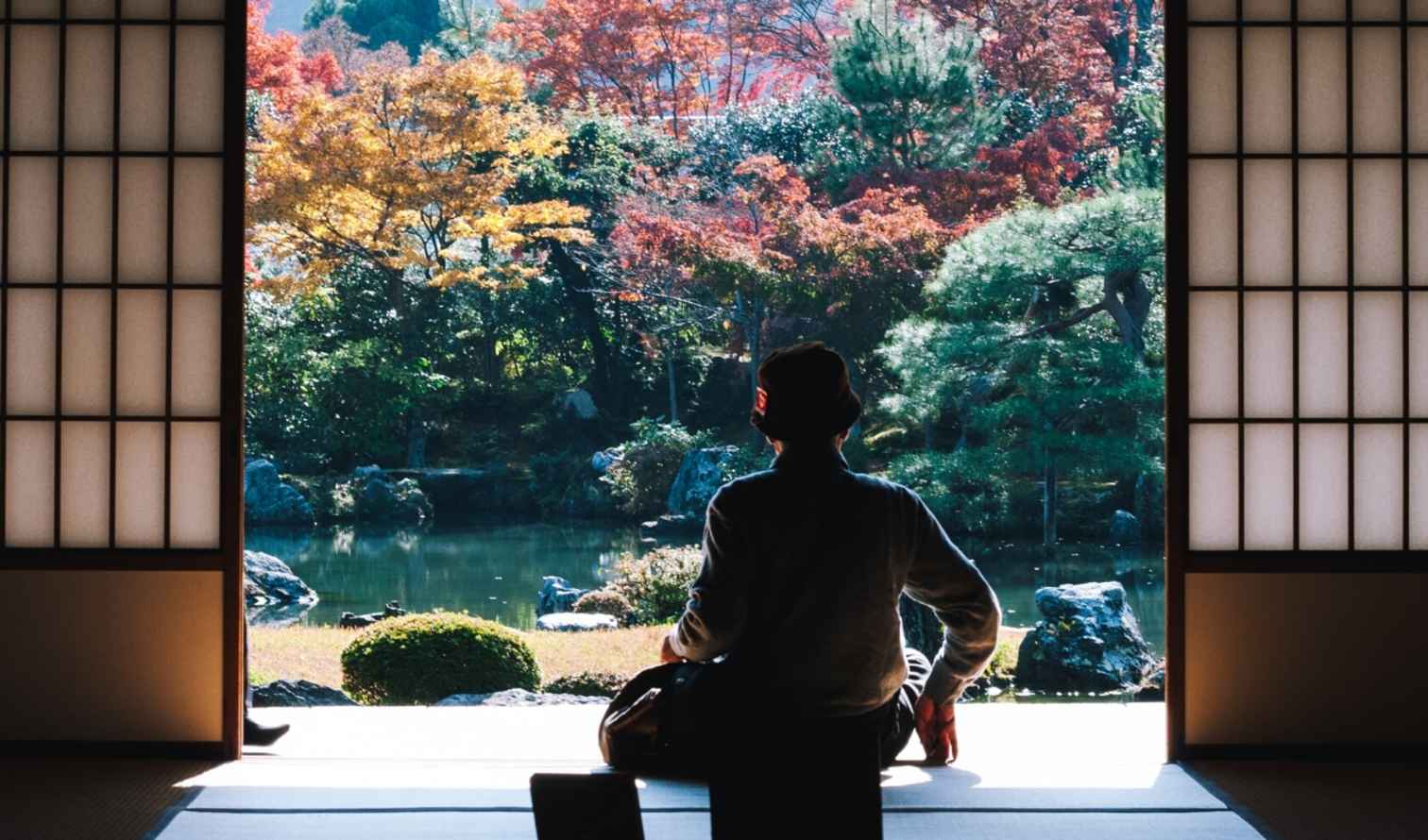 Person sitting in a traditional Japanese room facing a garden in Osaka