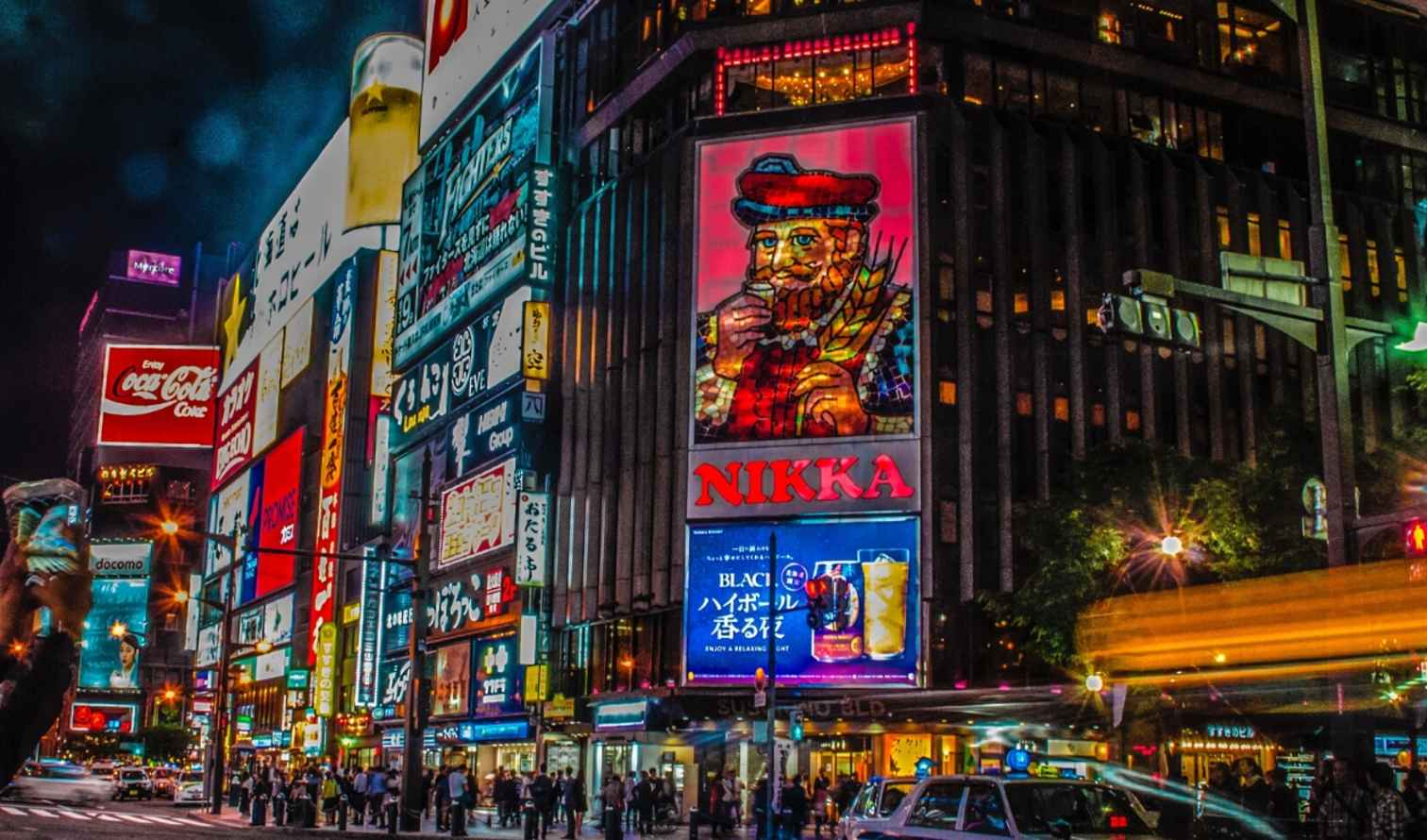 Susukino district in Sapporo with neon advertisements at night.